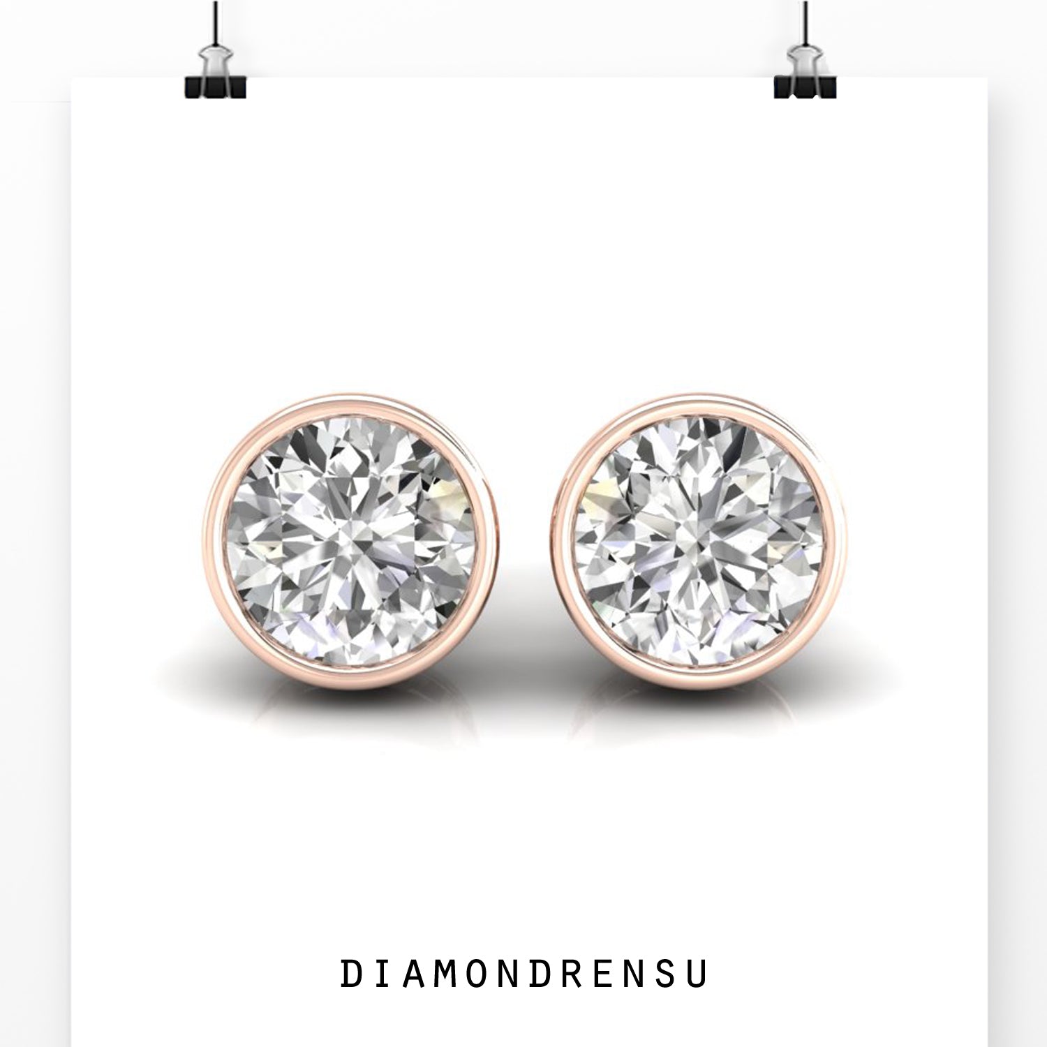 Gold diamond earrings with round cut stones and bezel setting.