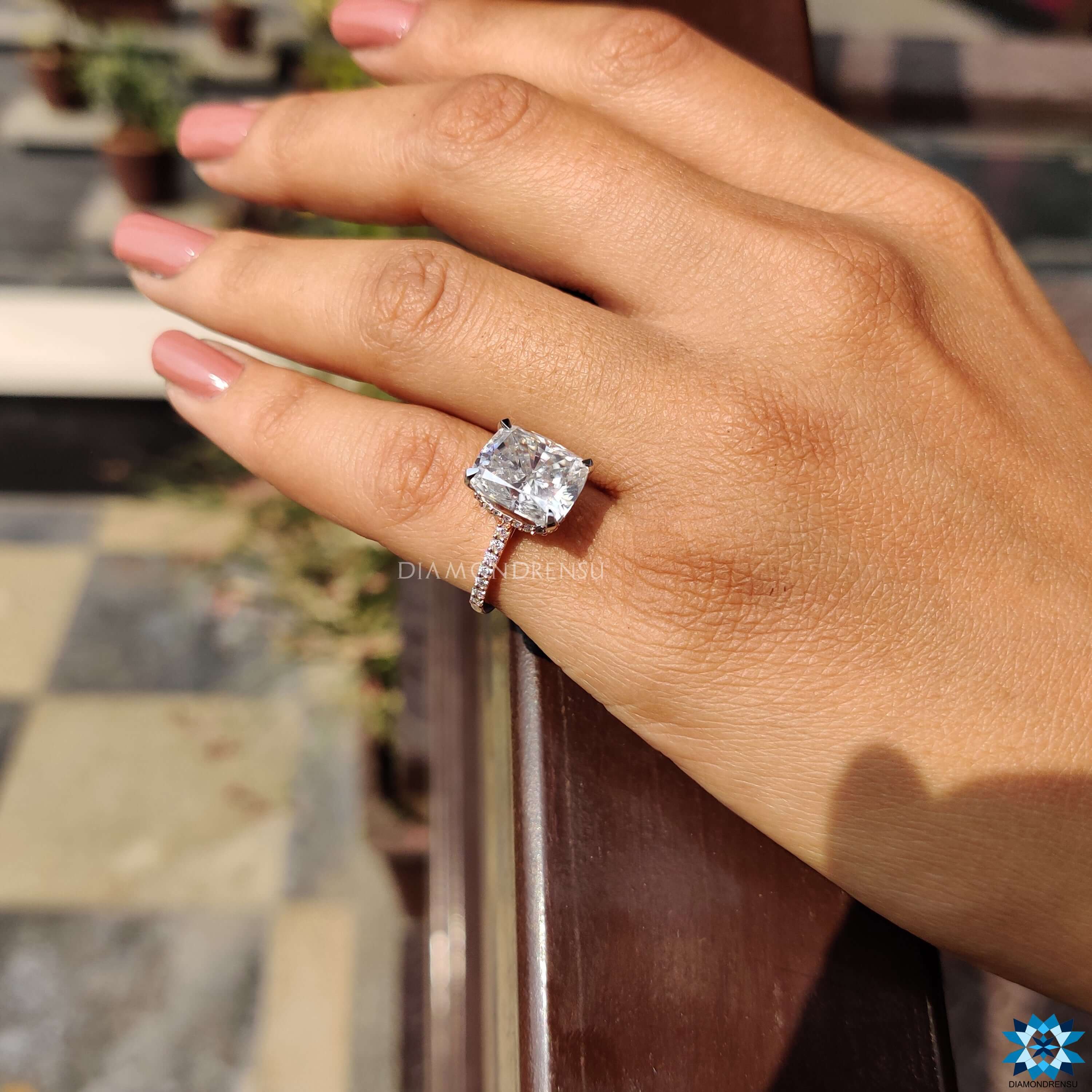 Unique engagement ring with cushion cut and rose halo.