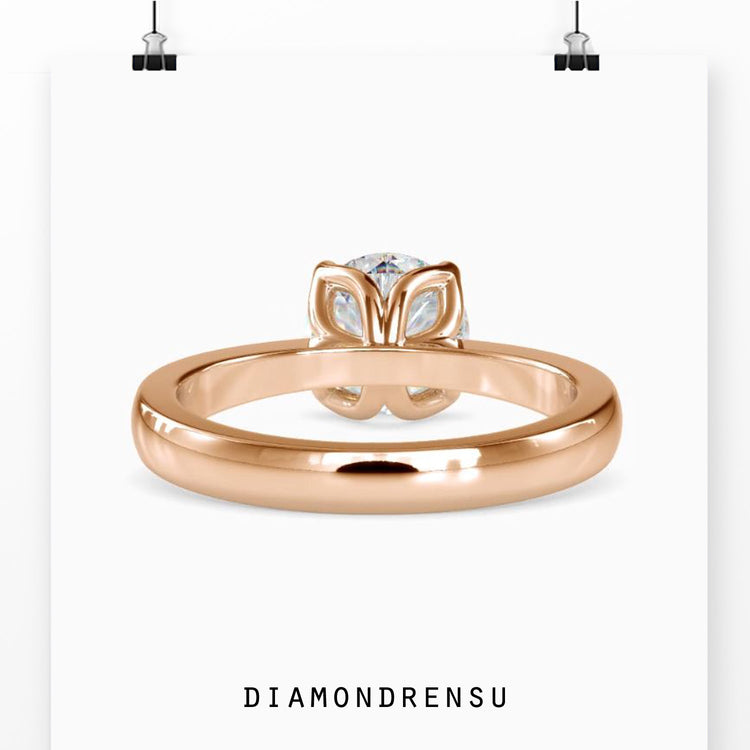 Simple diamond ring with tapered shank and prong setting.