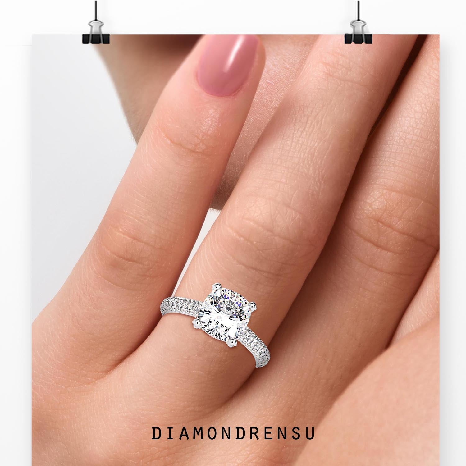 Pave setting ring with cushion cut centre diamond.