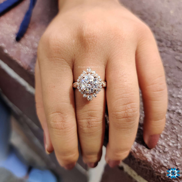 Vintage style moissanite ring in rose gold with prong setting.