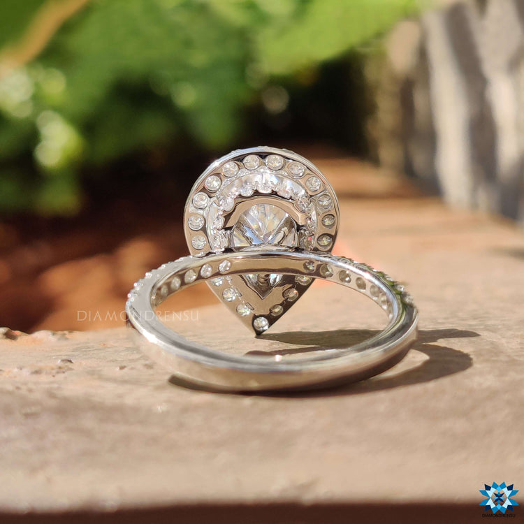 Moissanite halo ring featuring teardrop cut stone.