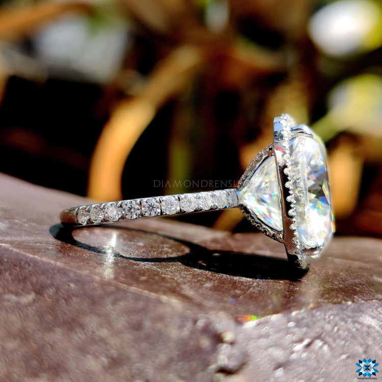 4 prong claw setting holding cushion cut center stone.