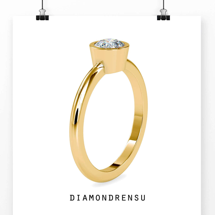 Handmade bezel ring with round cut diamond in simple design.