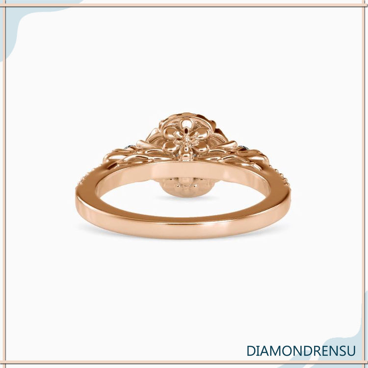 Floral halo ring in yellow gold with round prong setting.