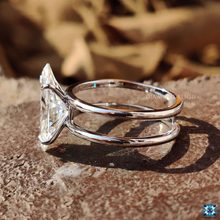 Dual shank engagement ring with 4 claw prong marquise setting.
