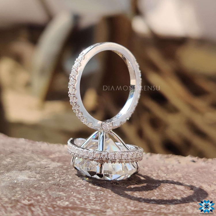 Vintage-style pear shape moissanite ring with hidden halo and pave band.