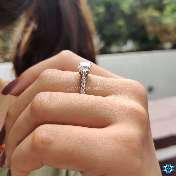 Moissanite ring featuring Portuguese cut stone in prong setting.