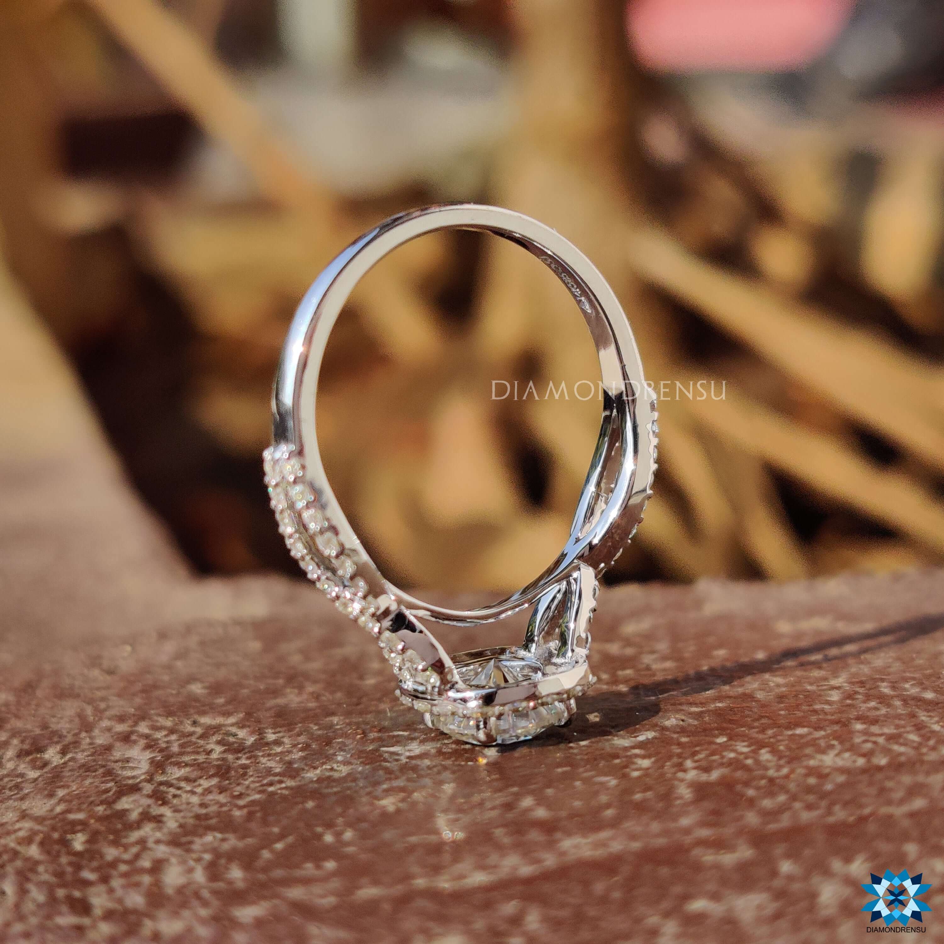 Prong setting moissanite ring with twisted pave detail.