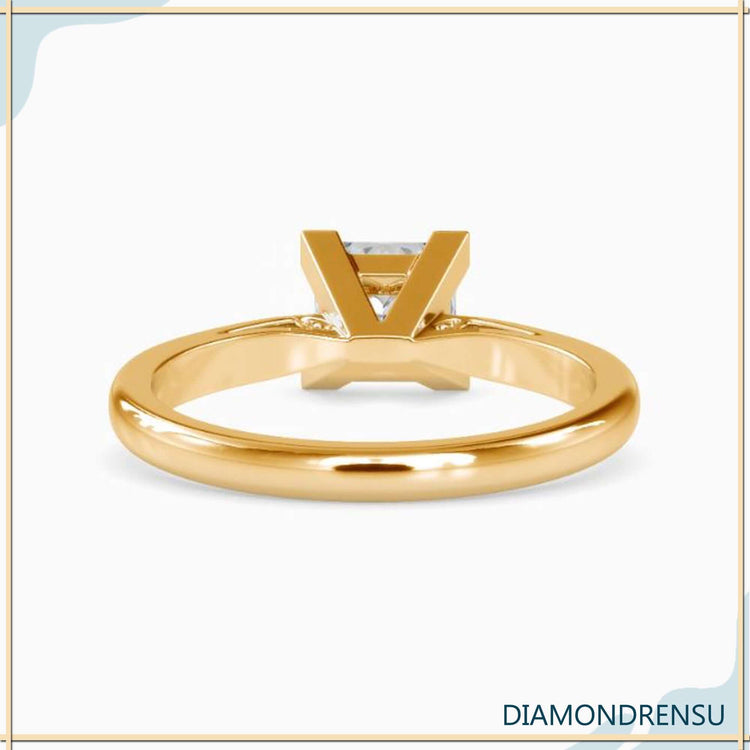 Solitaire engagement ring in rose gold with princess cut diamond.