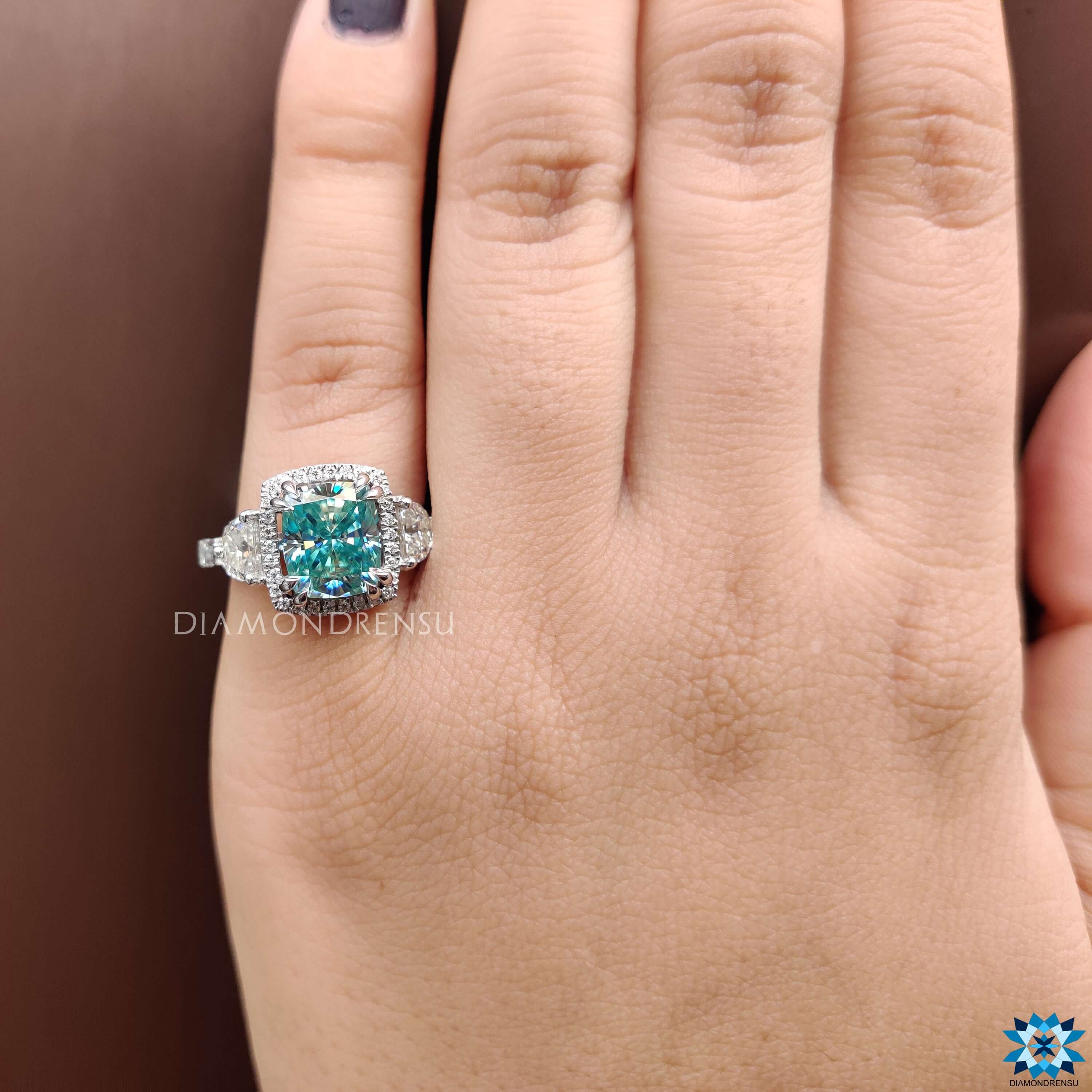 Handmade ring with blue moissanite and vintage-inspired design.