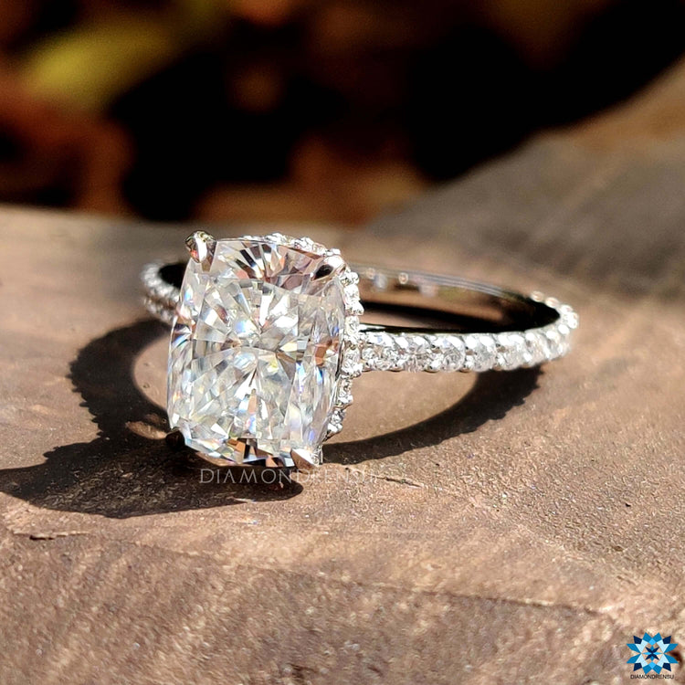 Pavé band ring with elongated cushion moissanite.