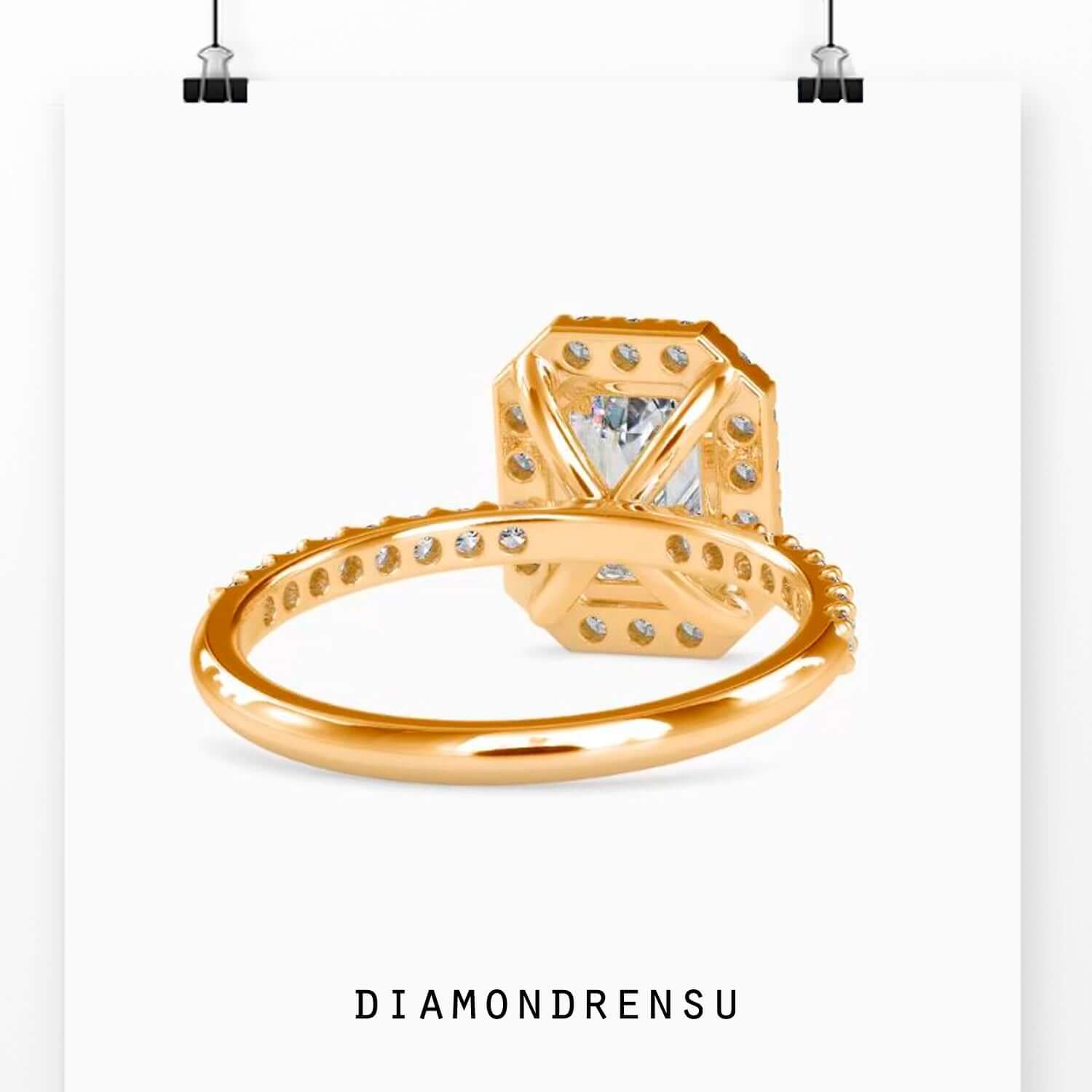 Customise engagement ring with emerald and halo design.