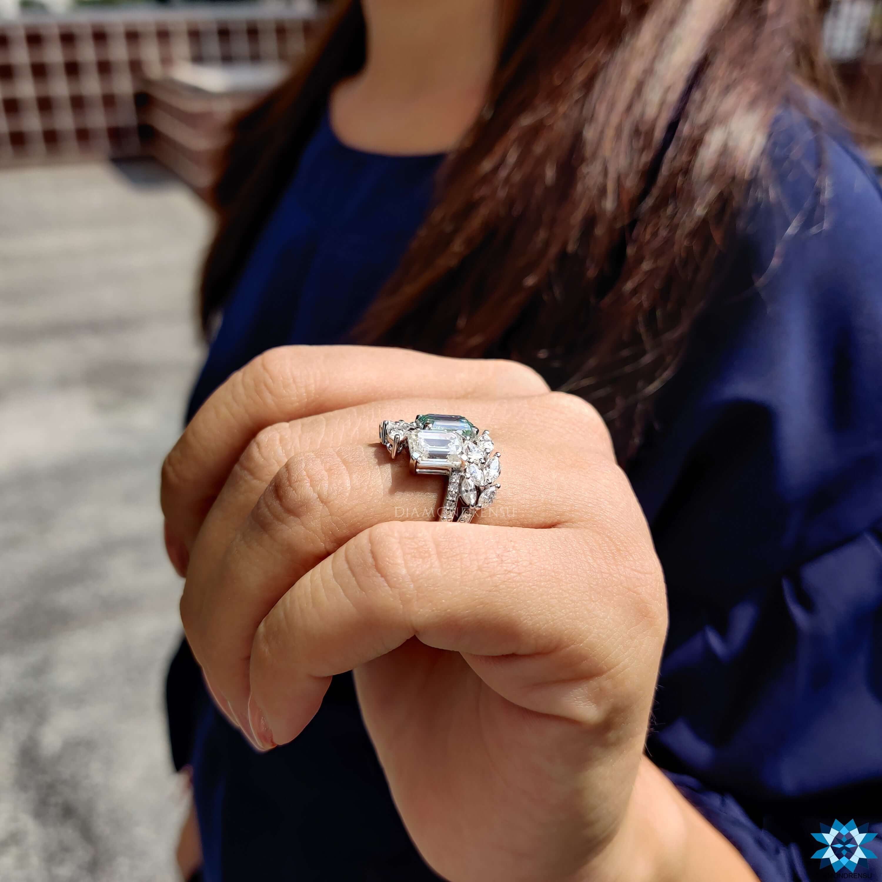 White gold moissanite ring featuring emerald center.