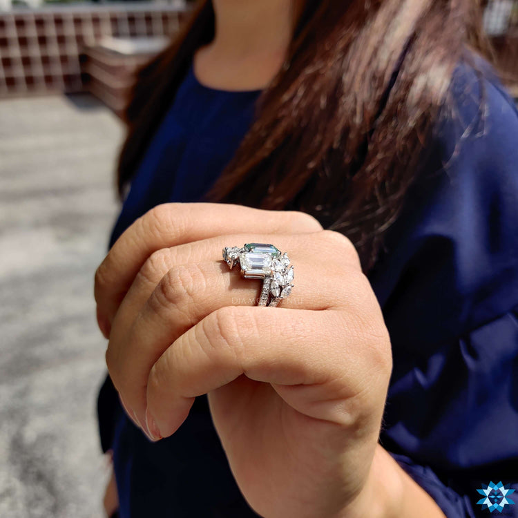 White gold moissanite ring featuring emerald center.
