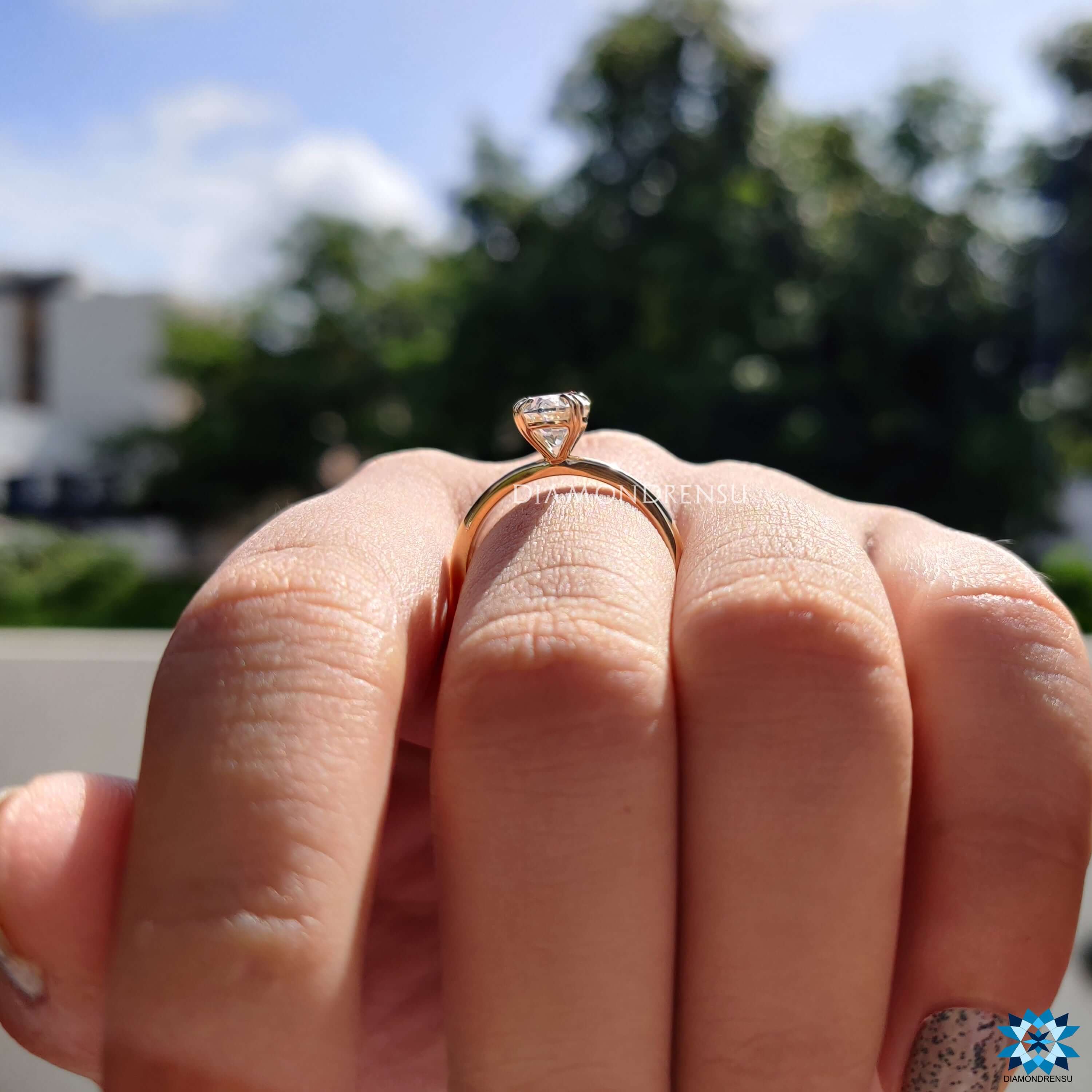 Custom engagement ring with oval moissanite centerpiece.