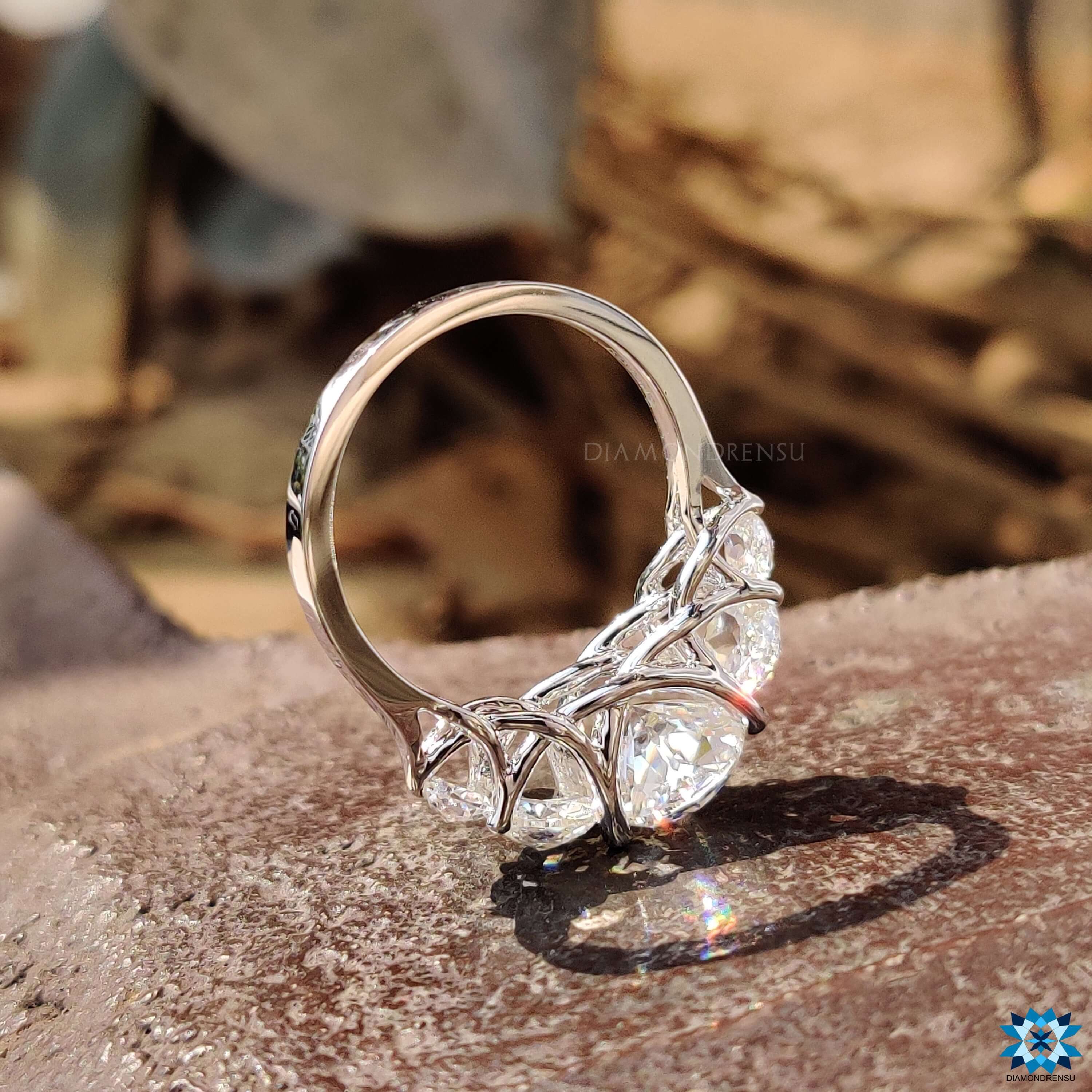 White gold engagement ring featuring five moissanite stones.