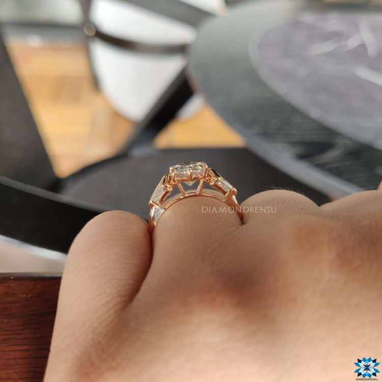 Rose gold ring featuring oval and kite moissanite cuts.