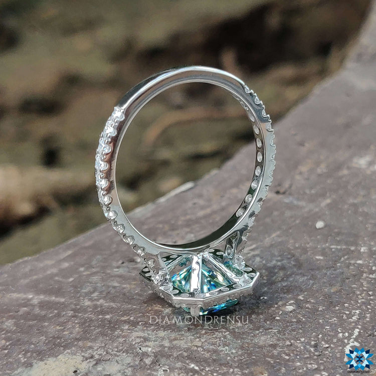 Custom radiant moissanite ring with round cut pave accents.