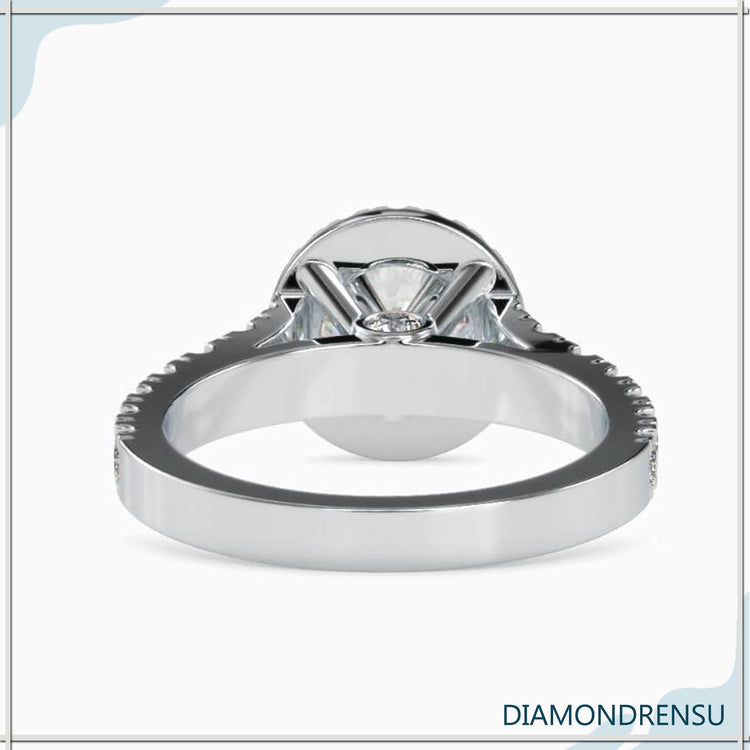 Yellow gold ring featuring round diamond and halo setting.