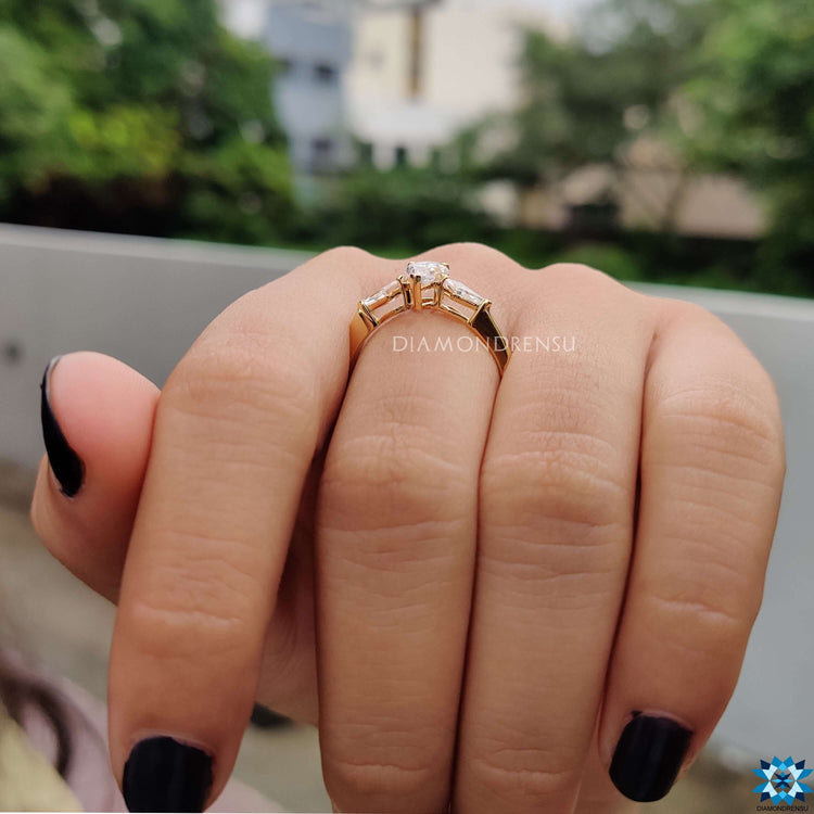 Handmade yellow gold three stone moissanite ring.