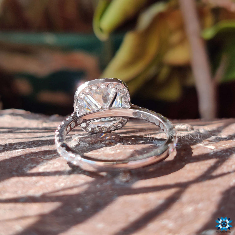 Halo moissanite ring with round cut pave band and 4 claw prongs.