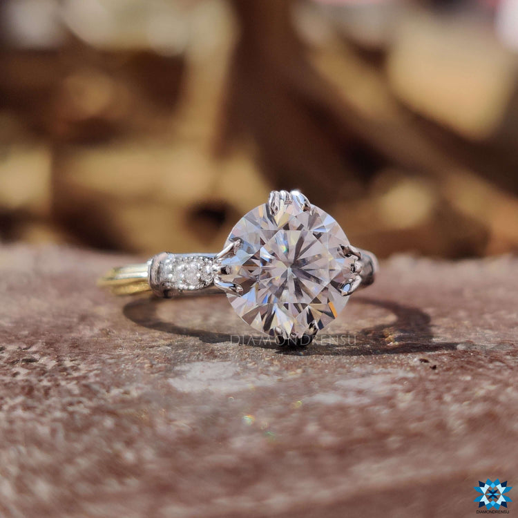 Yellow and white gold moissanite ring in round cut.