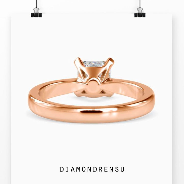 Handmade jewellery with princess cut solitaire on tapered shank.