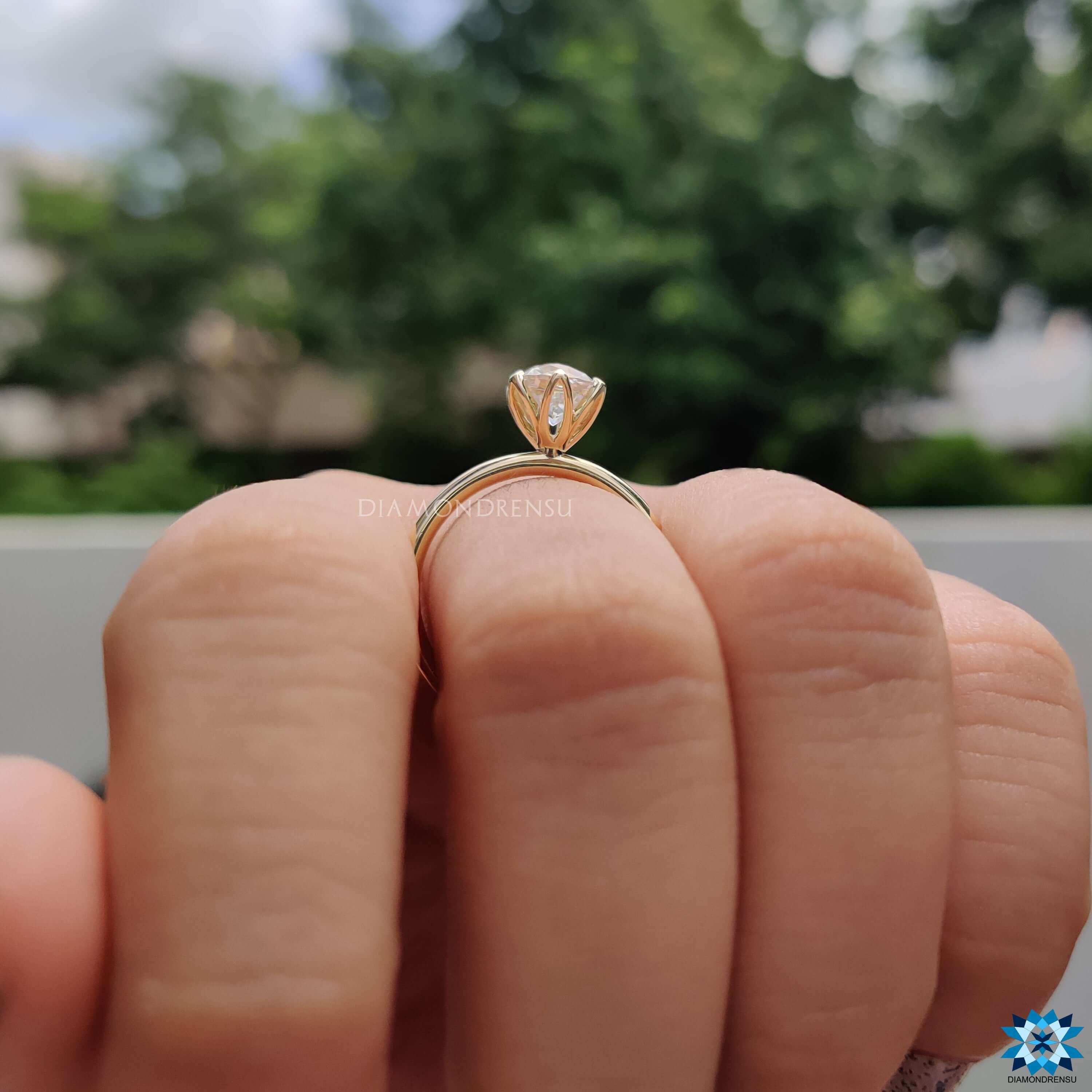 Handmade jewellery with tulip setting and moissanite center.