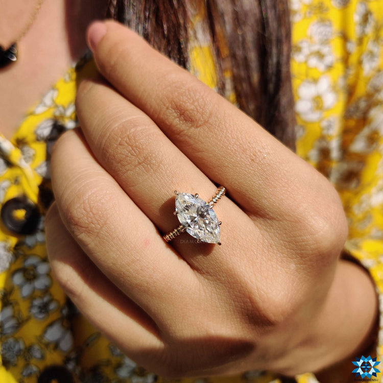 Marquise cut moissanite ring in solitaire setting.