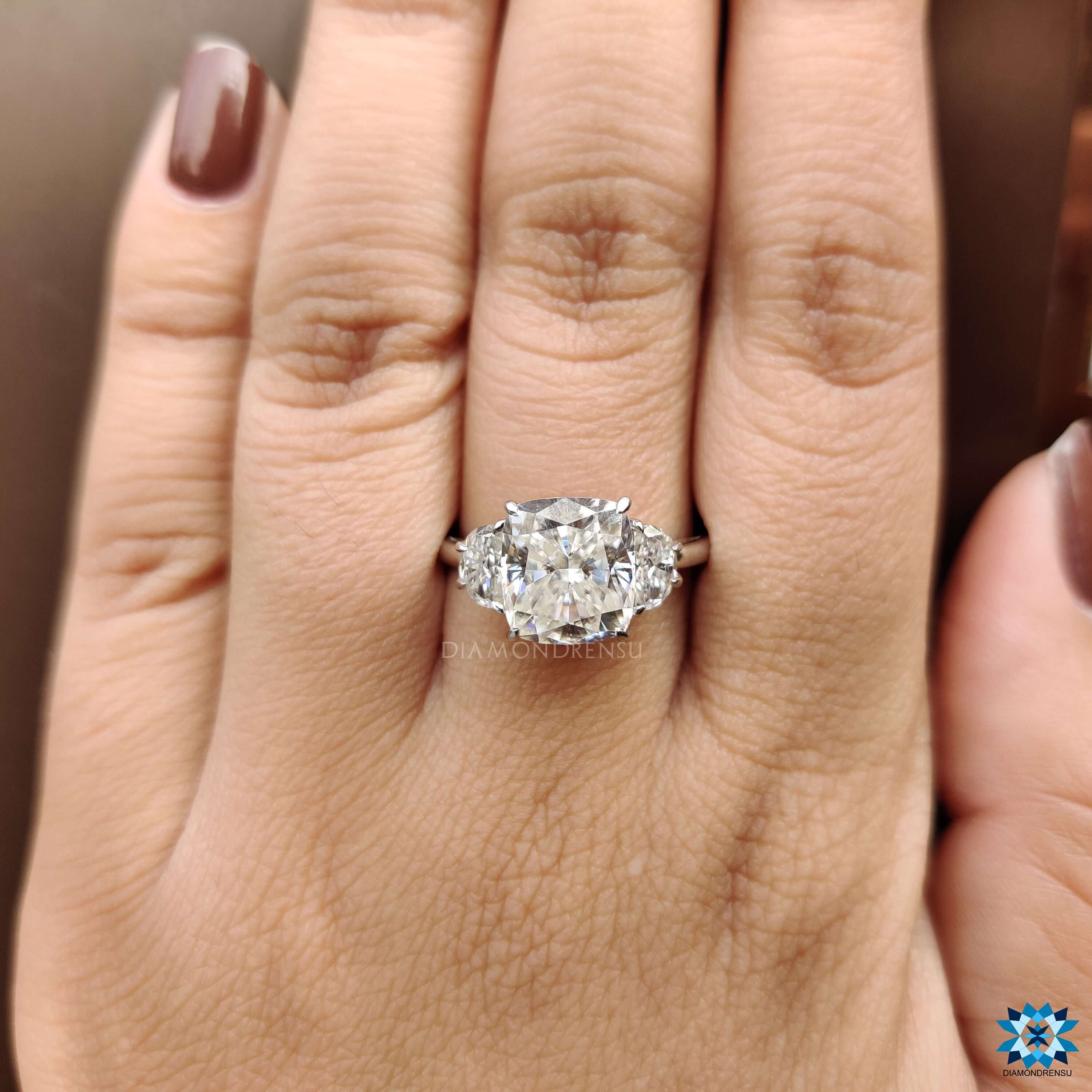 White gold cushion moissanite ring with prong setting.