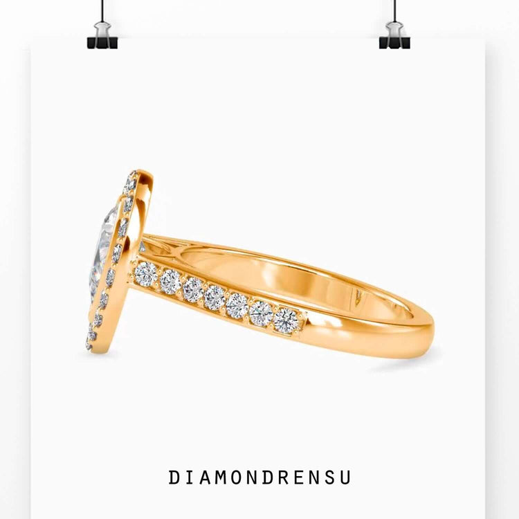 Designer ring with halo setting and pear cut diamond.