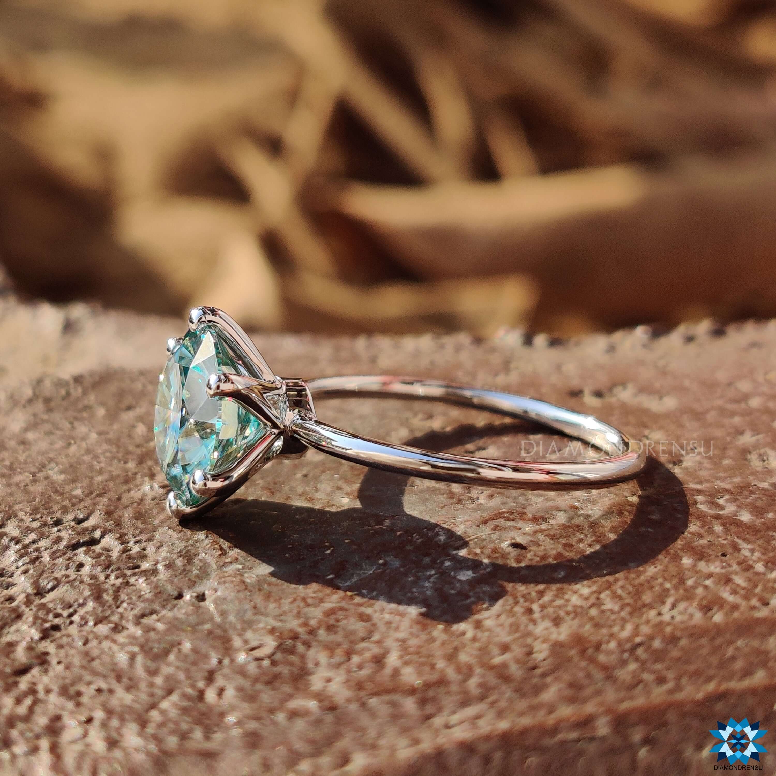 Handmade round moissanite ring with a minimalist solitaire style in white gold.