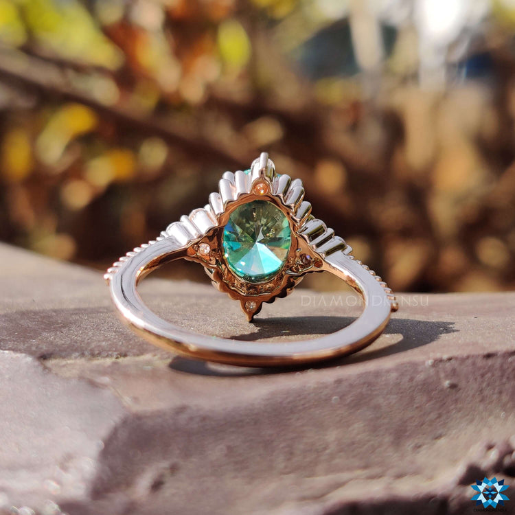 Rose gold ring with oval cut moissanite and prong setting.