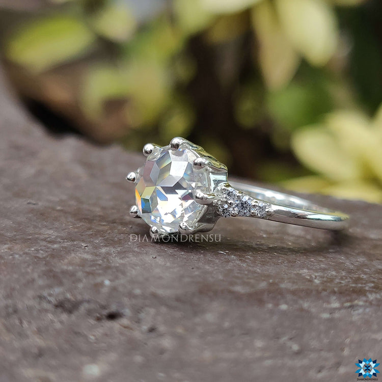 White gold engagement ring with rose cut Moissanite in a handcrafted setting.
