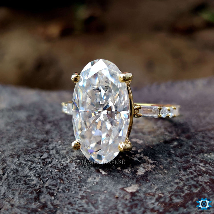 Custom engagement ring featuring moval cut moissanite in yellow gold.