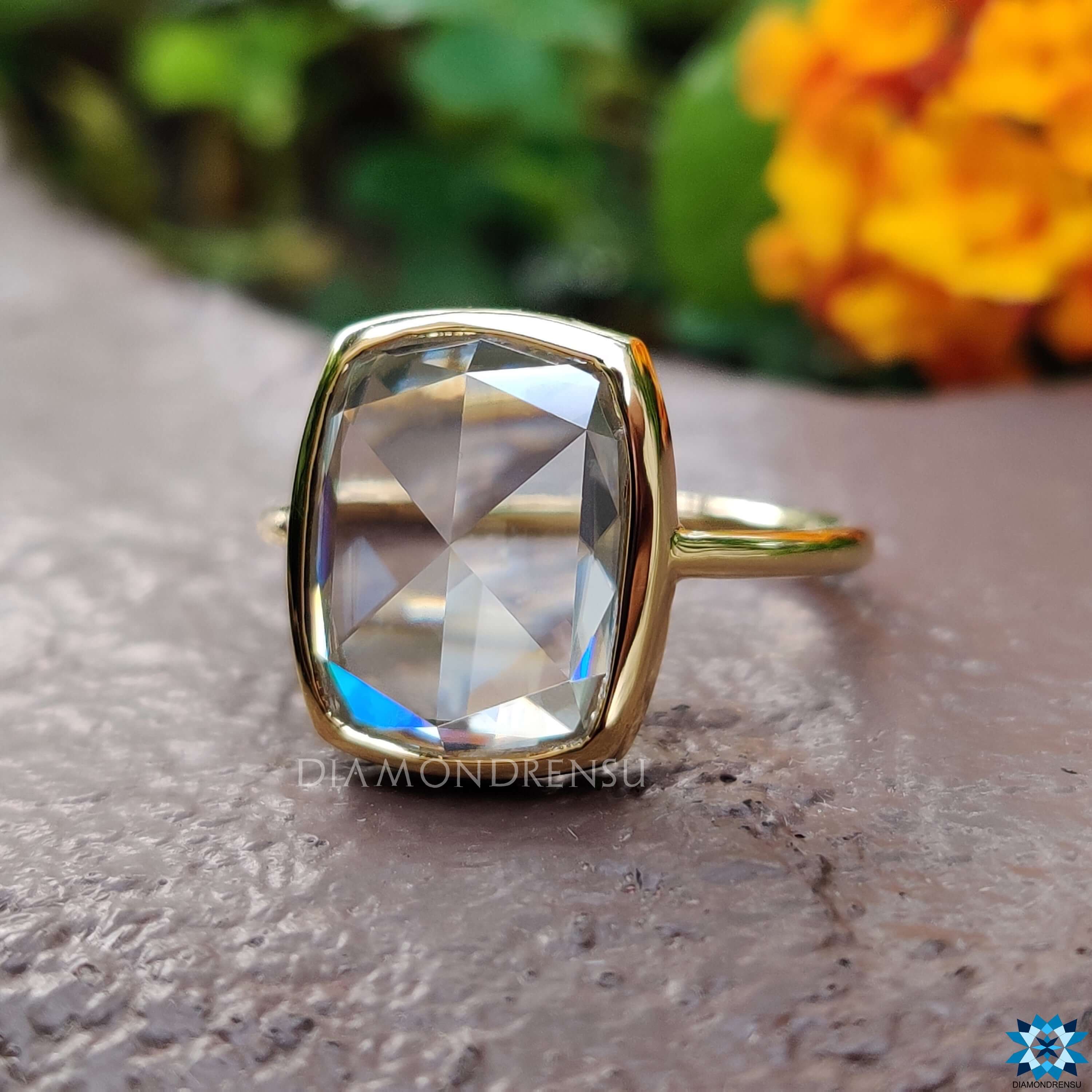 Yellow gold ring featuring elongated cushion cut moissanite.