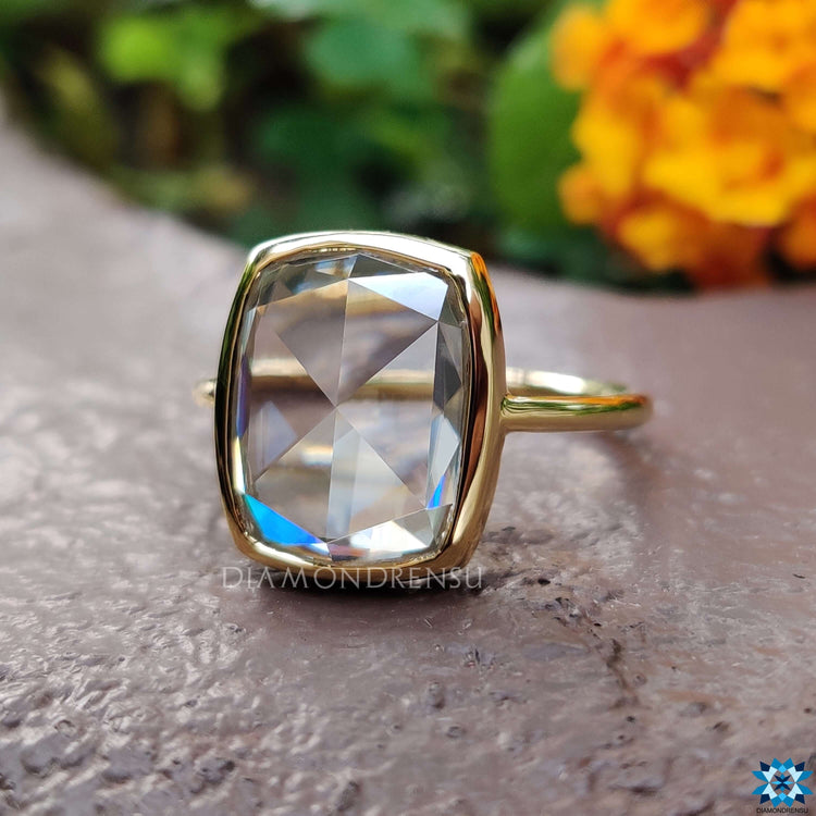 Yellow gold ring featuring elongated cushion cut moissanite.