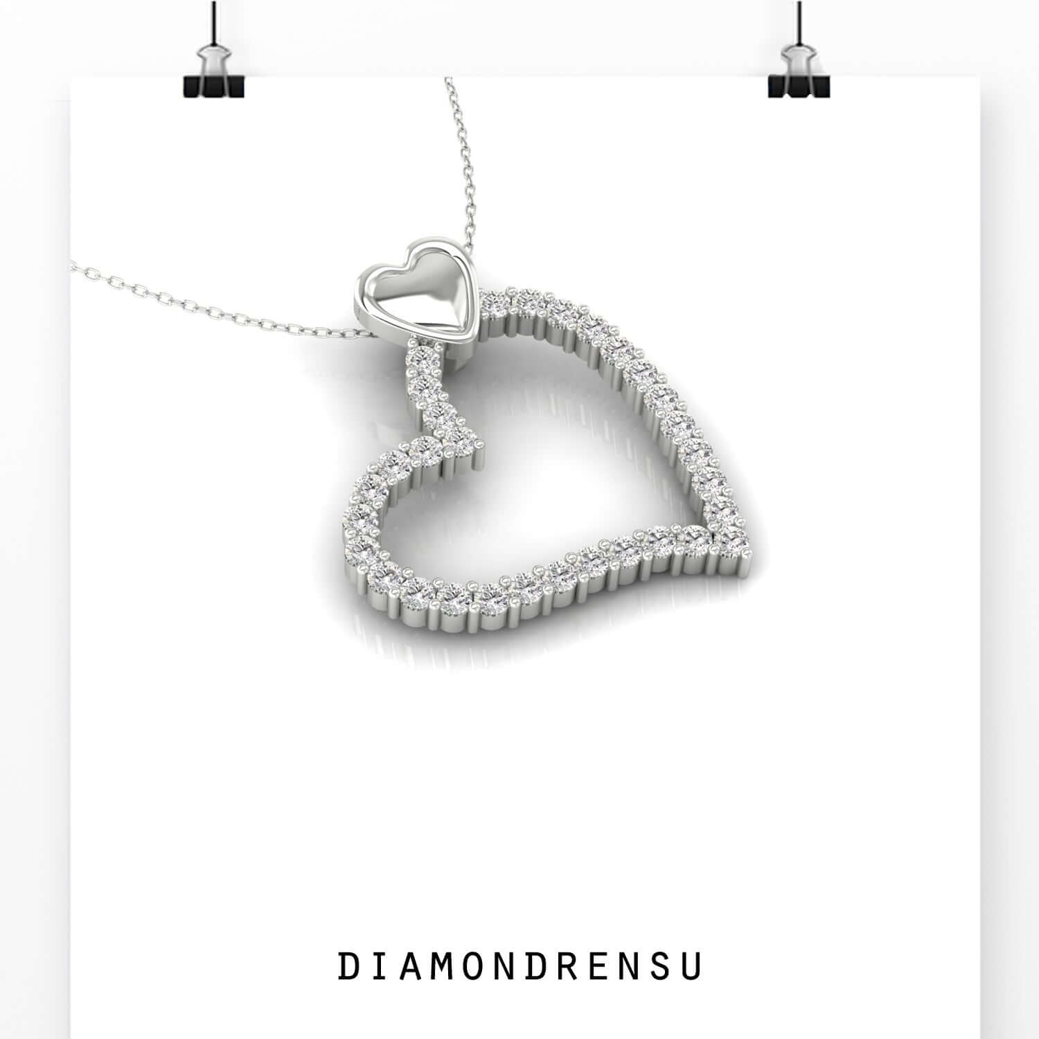 Handmade double heart pendant with shared prong diamond setting.