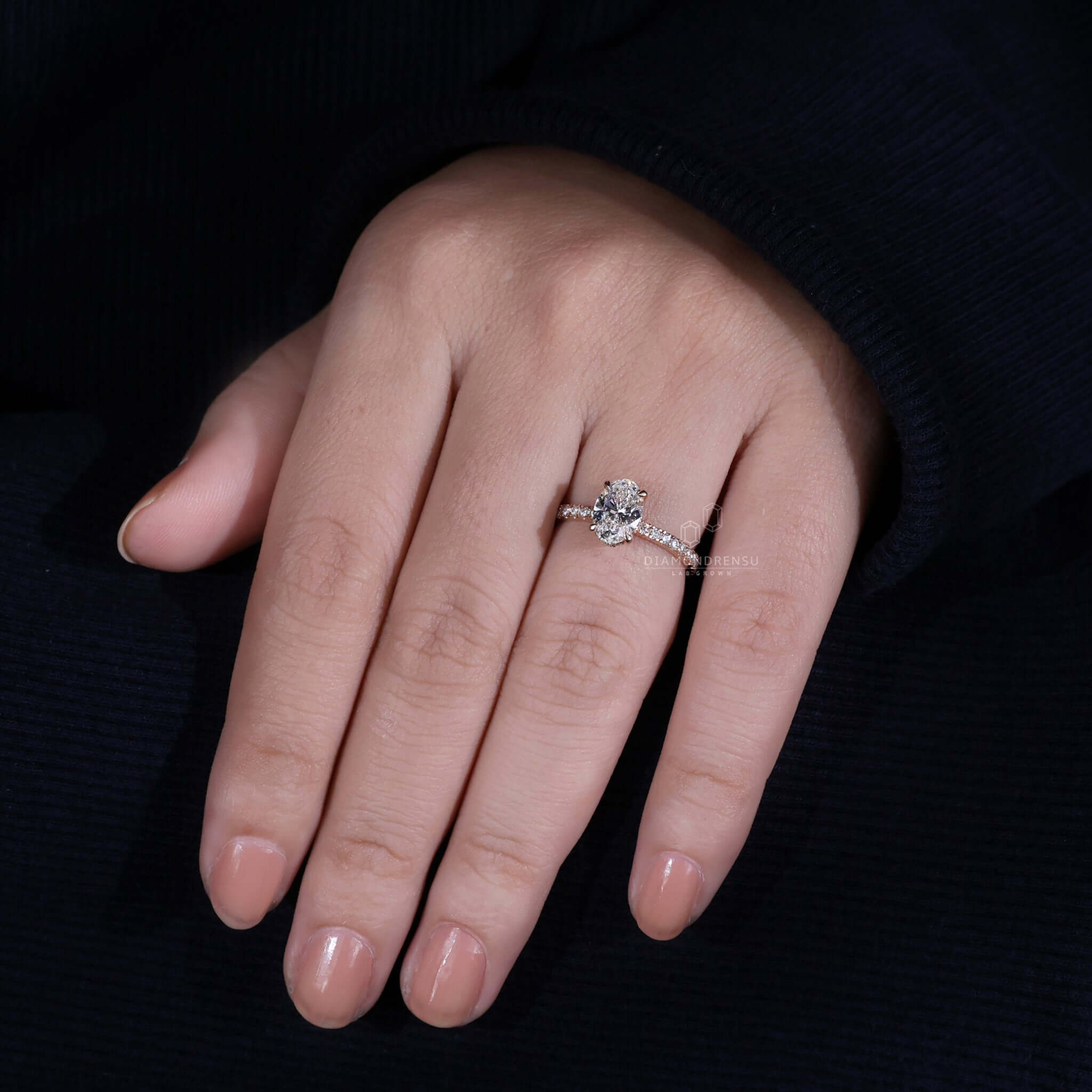 Oval engagement ring with hidden halo and a pave band, combining beauty and sophistication for engagement ring uk buyers.