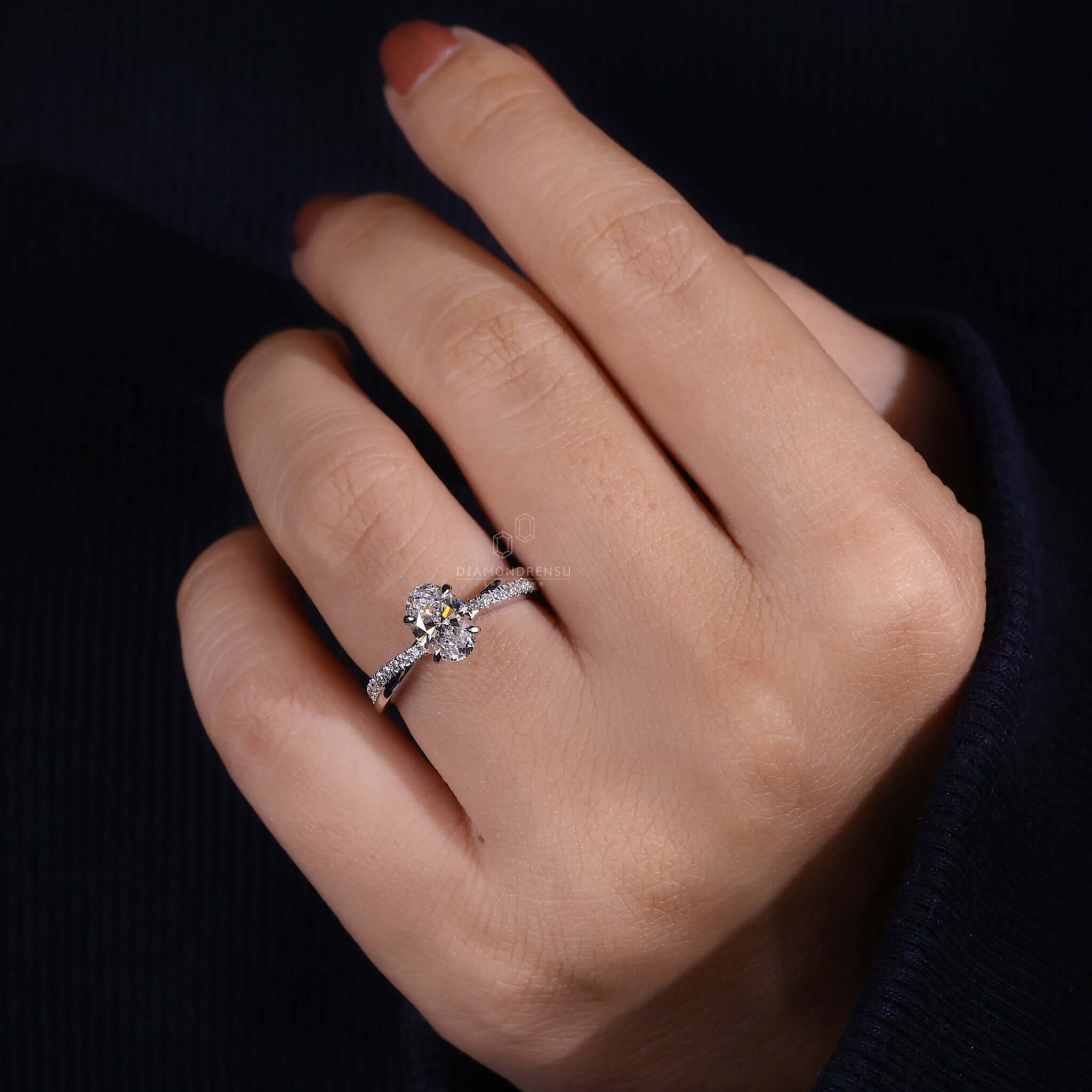 Twist engagement ring crafted with an oval diamond and pave diamonds, perfect as a unique engagement ring for women.