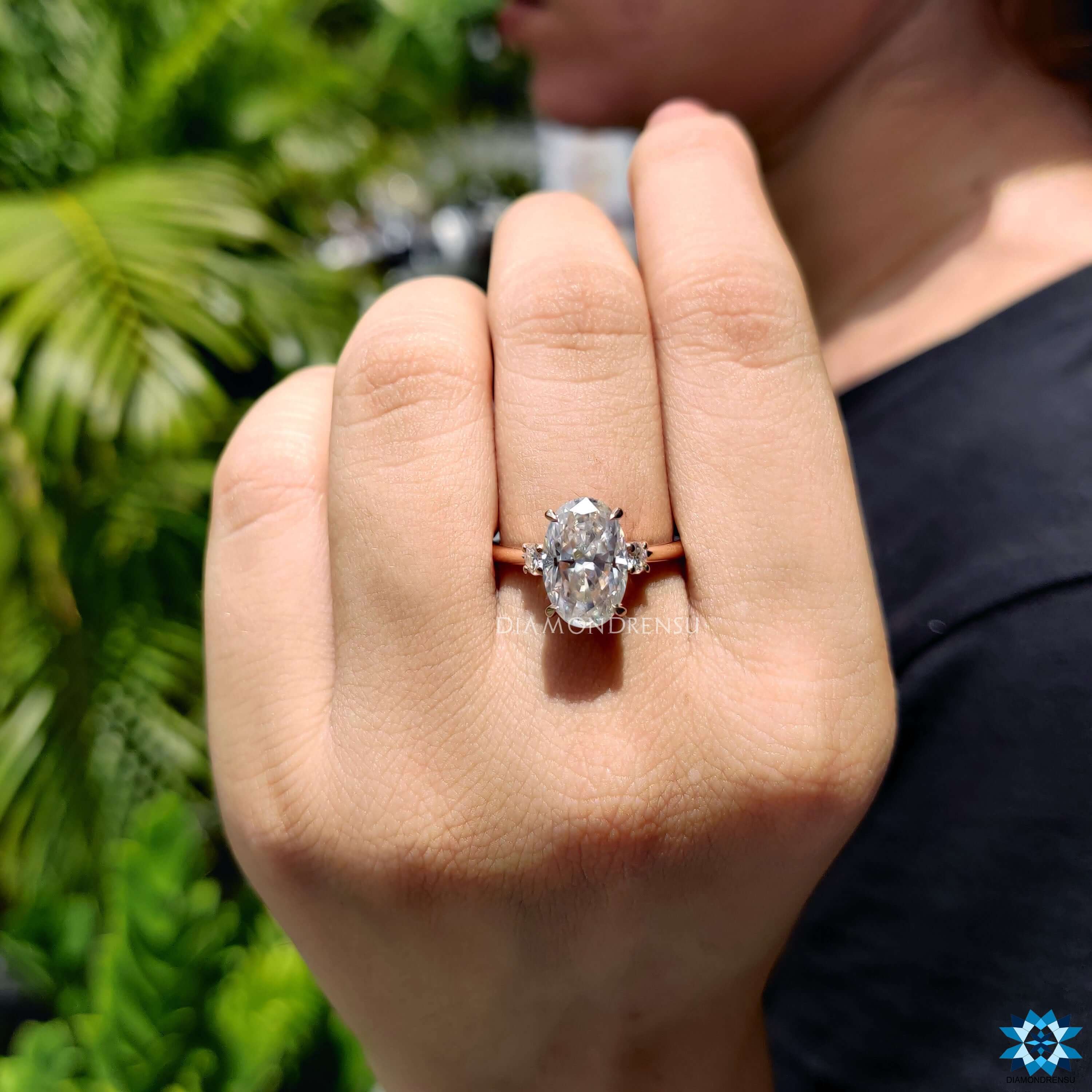 Oval cut moissanite engagement ring in rose gold.