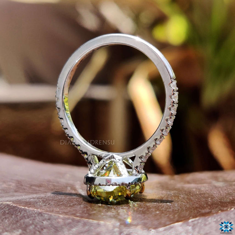Halo engagement ring featuring oval and round cut stones.