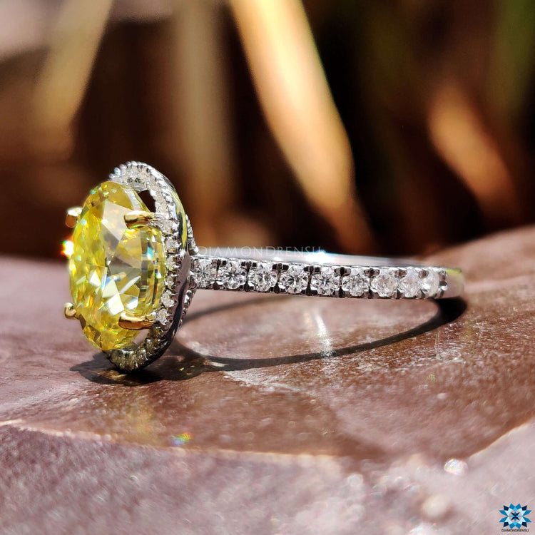 Custom handmade oval moissanite ring with four prong setting.
