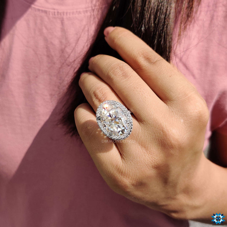 Oval moissanite ring featuring 2 side halo setting.