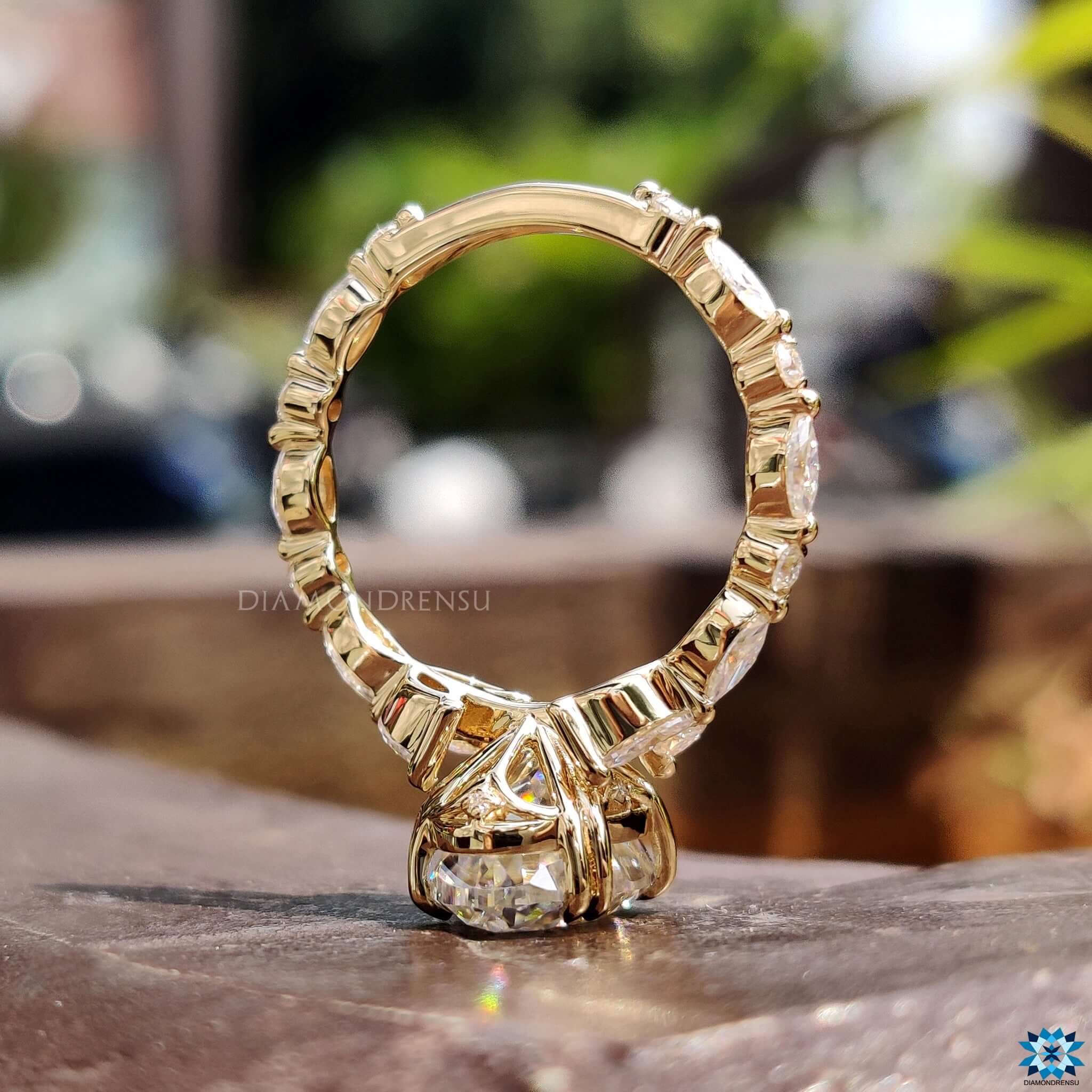 Yellow gold engagement ring with double claw prong and tulip setting.