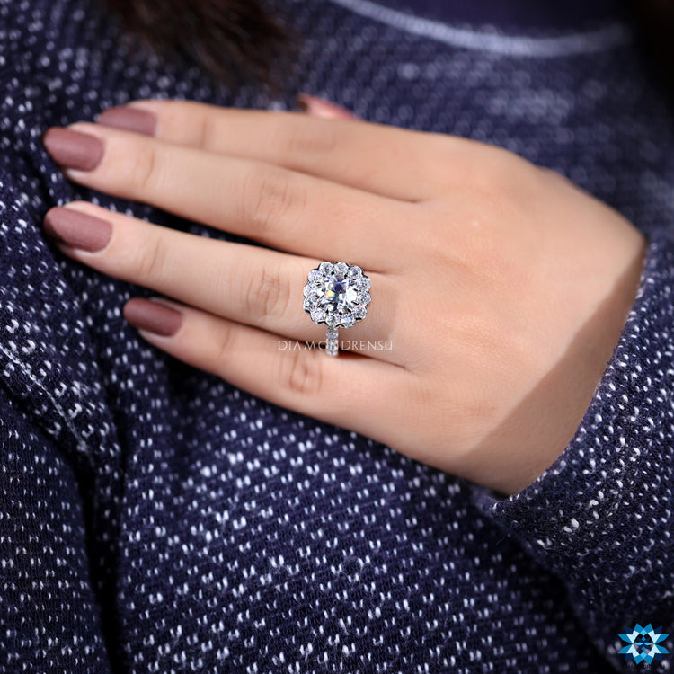 Custom engagement ring with cushion moissanite and pave round cut band.