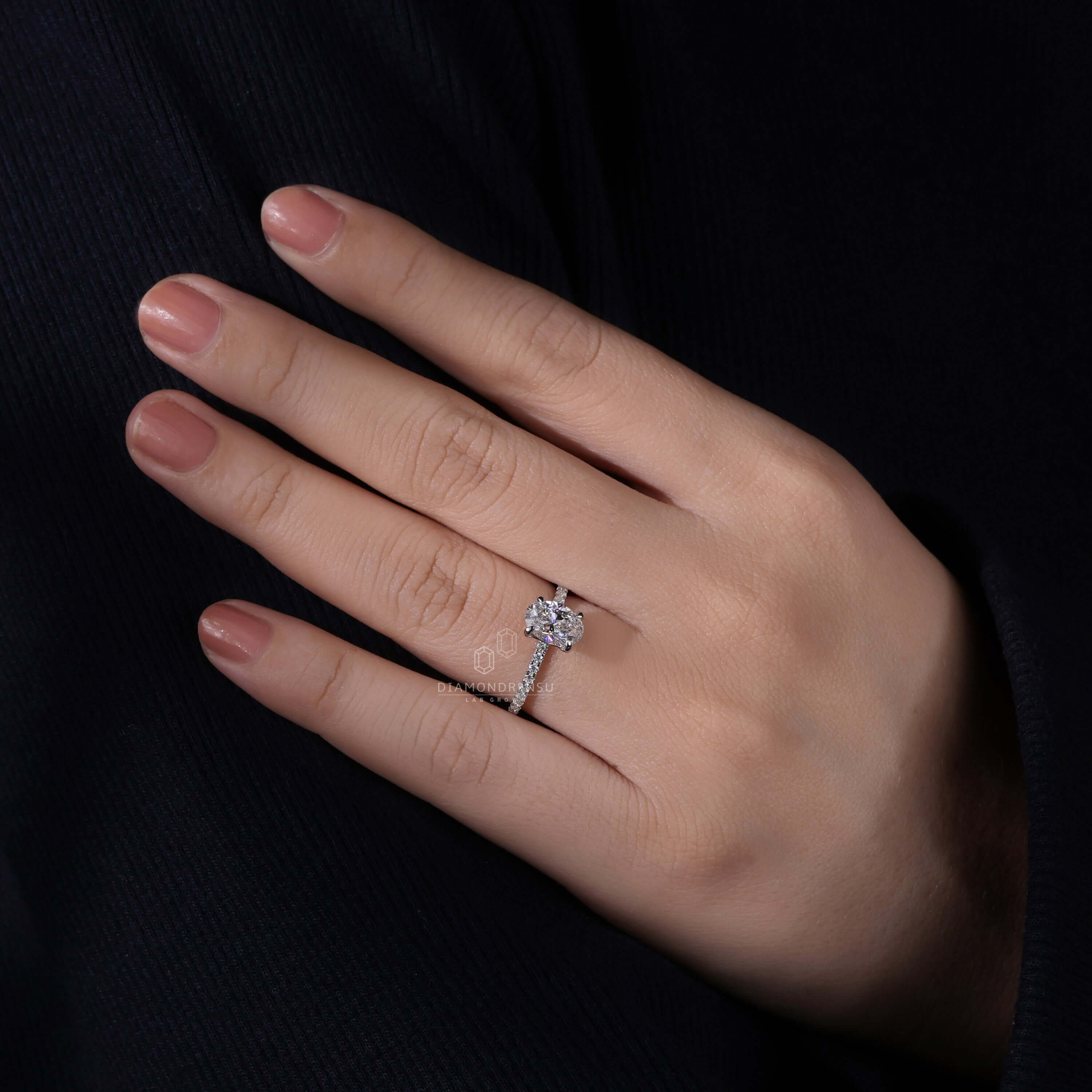 Engagement ring with pave design and 1.5 carat oval diamond, expertly crafted for a special occasion.