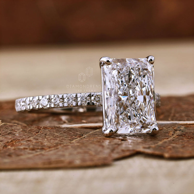 Pave diamond ring designed with a radiant cut diamond, perfect as a unique engagement ring.