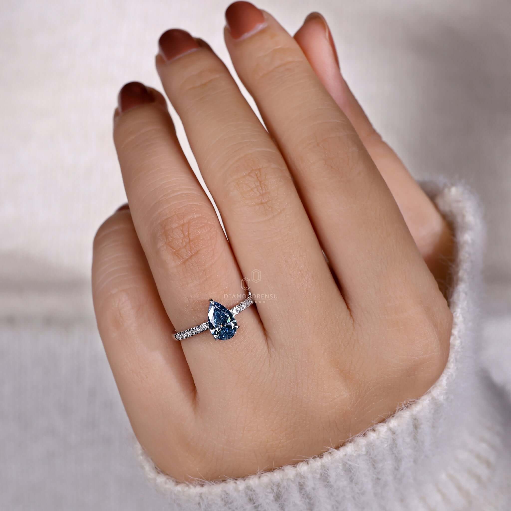 Blue diamond ring in a 3 prong claw setting, ideal for women seeking unique engagement rings.